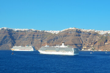 Wall Mural - Santorini island, Aegean Sea, Greece. Cruise ships moored in the blue sea Caldera in front of island. 