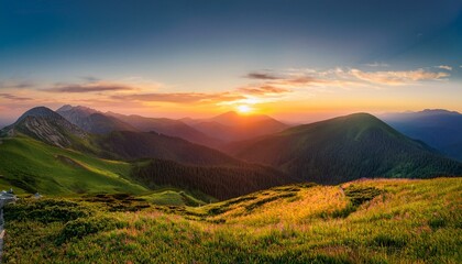 Wall Mural - Sunset over rolling green hills and mountains.