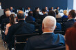© tsuguliev - Audience at the modern conference hall listens to panel discussion, people on a congress event together listen to speaker on stage at convention, business seminar, large venue for forum presentation