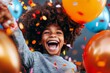 © Thanyarat - A child holding a balloon and smiling widely during a festive celebration, surrounded by colorful decorations