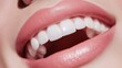 © wikkie - Close-up of a smiling mouth showcasing bright, white teeth and soft pink lips.