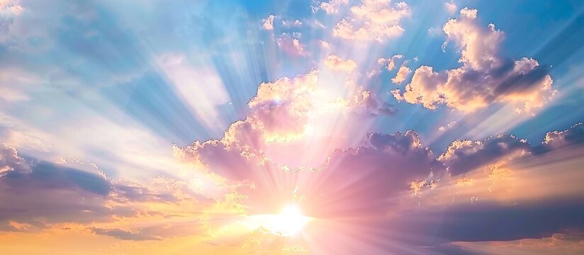 heavenly sunrise. peaceful pastel colors paint the sky as sun rays burst through the clouds.
