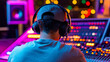 © kaliel - Focused audio producer working on a mixing console with colorful LED indicators in a vibrant music studio environment.