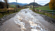 © bcendet - Flooded rural road, autumn landscape, mountain background, impassable