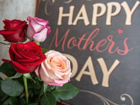 Happy mothers day greeting cards design with colorful flowers in pink, white  background