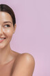 © Buyanskyy Production - Close-up of a young Caucasian woman with flawless skin and a bright smile against a soft pink background, symbolizing beauty, skincare, and self-care. Perfect for wellness and cosmetic branding.