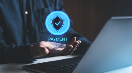 Poster - Digital payment security concept with shield icon hovering over a hand near laptop.