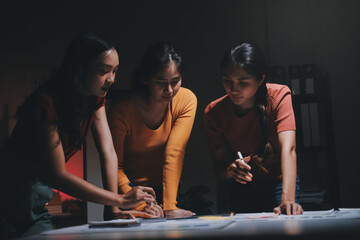 Canvas Print - Business people working late at laptop in highrise office