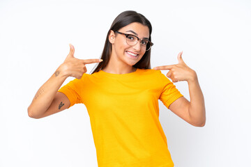 Wall Mural - Young caucasian woman isolated on white background giving a thumbs up gesture