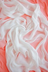 Poster - Delicate white fabric draped gracefully over a coral background, perfect for backgrounds and artistic compositions.