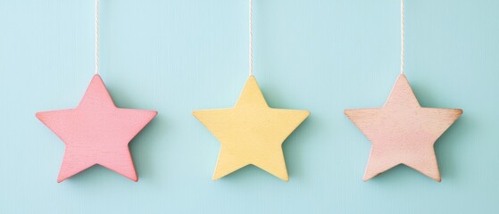 Poster - Colorful wooden stars hanging against a light blue background, perfect for adding a whimsical touch to children's decor or festive themes.