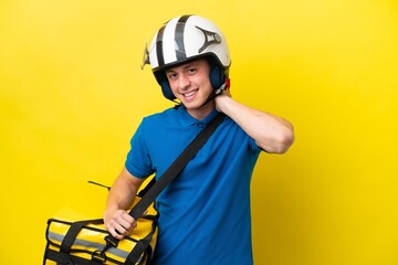 Wall Mural - Young Brazilian man with thermal backpack isolated on yellow background laughing