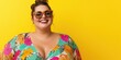 © Iryna - A woman with a big smile on her face is wearing a colorful floral dress and sunglasses. She is posing for a photo on a yellow background