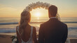© thongsook - A romantic wedding ceremony on the beach at sunset with the couple standing under an arch decorated with white flowers