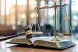 © Alexei - A traditional scale of justice is positioned atop a book placed on a table