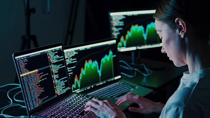 Leinwandbilder - Analyzing data trends with dual monitors and coding on laptop in modern workspace