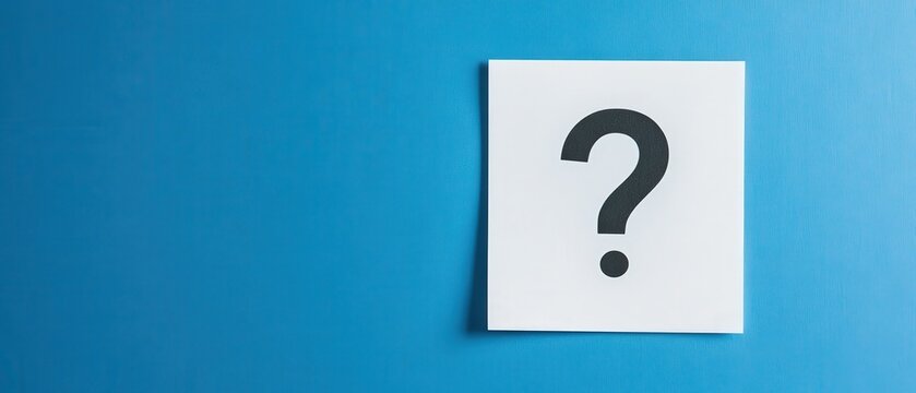 A question mark positioned on a piece of paper with a blue background