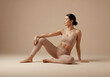 © arastudio - A Woman in a Beige Activewear Set, Posing Relaxedly