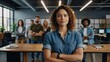 © muqadas - A confident and creative woman standing with arms crossed in a vibrant startup office