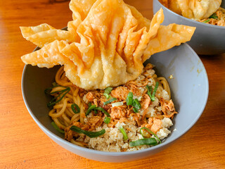 Wall Mural - Fried noodles with minced meat and fried dumplings in a bowl. Chinese food.