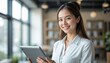 © aiartth - A young, smiling businesswoman or teacher in an office setting, holding a digital tablet.