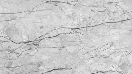 Leinwandbilder - A white marble wall with cracks and holes. The wall is smooth and shiny, but the cracks and holes give it a rough and aged appearance. The contrast between the smooth surface