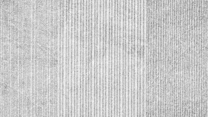 Aufkleber - A gray and white striped background with a gray and white striped carpet in the middle. The stripes on the carpet are of varying widths and are arranged in a way that creates a sense of depth