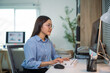 © Crystal - Young Asian businesswoman working from home typing on computer keyboard
