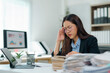 © Crystal - Stressed businesswoman having headache while working with documents in office