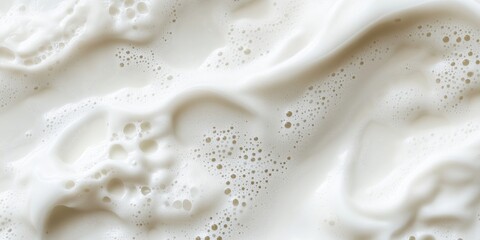 Poster - Creamy white liquid texture with bubbles and foam, resembling milk or cream, showcasing smooth flow and soft peaks