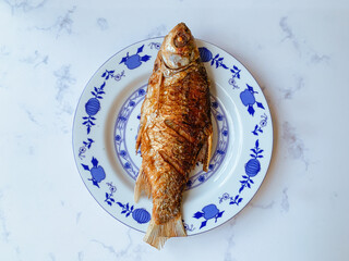 Wall Mural - Fried Kendia fish or Thynnichthys on a plate