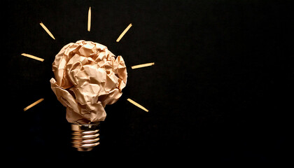 Poster - Creative crumpled paper lightbulb on black background.  Symbolic image perfect for ideas, innovation, solutions, and brainstorming concepts. Ideal for websites, presentations, and marketing materials.