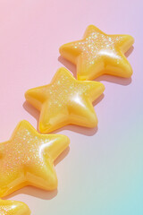 Poster - Shiny yellow star-shaped objects with sparkling glitter on a soft pink and pastel-colored background