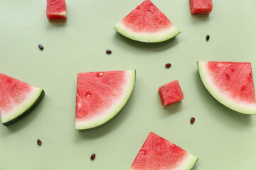 Sticker - Pieces of fresh watermelon and seeds on green background