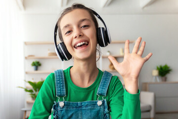 Poster - Distance Learning. Cute teenage girl having video lesson using laptop in living room, studying with computer, enjoying online education, waving hand, pc web camera view