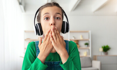 Aufkleber - Headshot of shocked amazed schoolgirl in headset looking at pc screen in disbelief, reading news watching video having online call on laptop covering mouth, web camera point of view