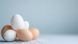 © inspiretta - Group of eggs with a blue, pink, and white sprinkles on the ground
