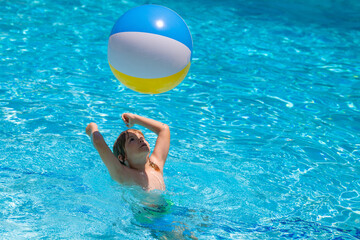 Wall Mural - Boy kid swimming and playing in a pool. Child playing in swim pool. Summer fashion kids portrait. Vacation in a tropical resort. Swimwear for children. Summer rest and relaxation.