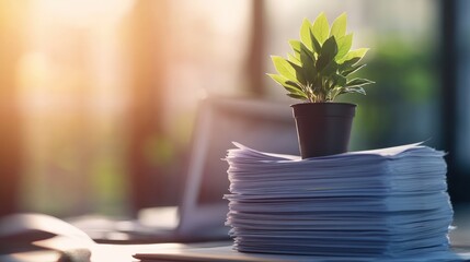 Poster - Green plant growing in a small pot on a stack of documents in a modern office, representing growth, innovation, and sustainable work practices in a contemporary environment