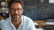 © Mechastock - A male teacher smiles confidently while interacting with students in a lively classroom