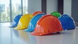 © Theeranan - A Vibrant Array of Hard Hats in Various Colors Displayed on a Table in an Indoor Environment with Natural Light Streaming Through the Windows