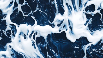 Abstract wave pattern with white foam contrasting against a deep blue backdrop