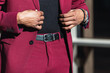 © BUDDHA - Details of businessman adjusting trendy red suit