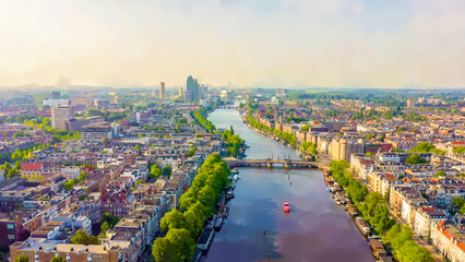 Wall Mural - Amsterdam, Netherlands. Watercolor illustration. Flying over the city rooftops. Amstel River, Aerial View