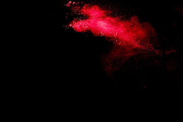 Wall Mural - red dust particles explosioon on black background.red powder splash.