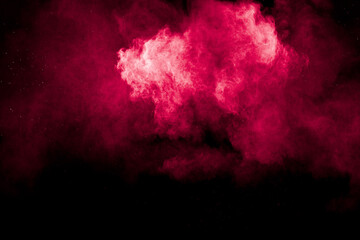 Wall Mural - a red cloud of powder on black background.
