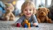© Atchariya63 - Happy toddler playing with colorful stacking toys on a cozy rug.