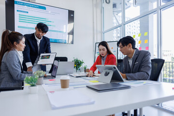 Wall Mural - Group of Business people planning at whiteboard in office meeting,team business work with documents tax laptop computer in office.	