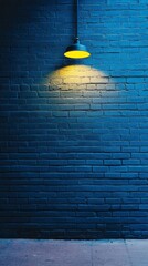 Poster - Against a deep blue backdrop, a solitary yellow light casts a warm glow, highlighting the unique texture of the brick wall. This captivating contrast creates an enchanting atmosphere