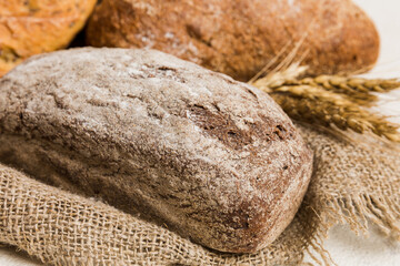 Wall Mural - Homemade natural breads. Different kinds of fresh bread as background, perspective view with copy space